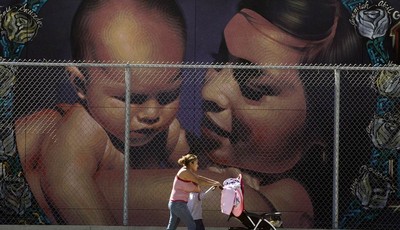 
              A mother walks with her children to the MacArthur Park Primary Center School in Los Angeles Thursday, Jan. 31, 2013. Within six months, California
